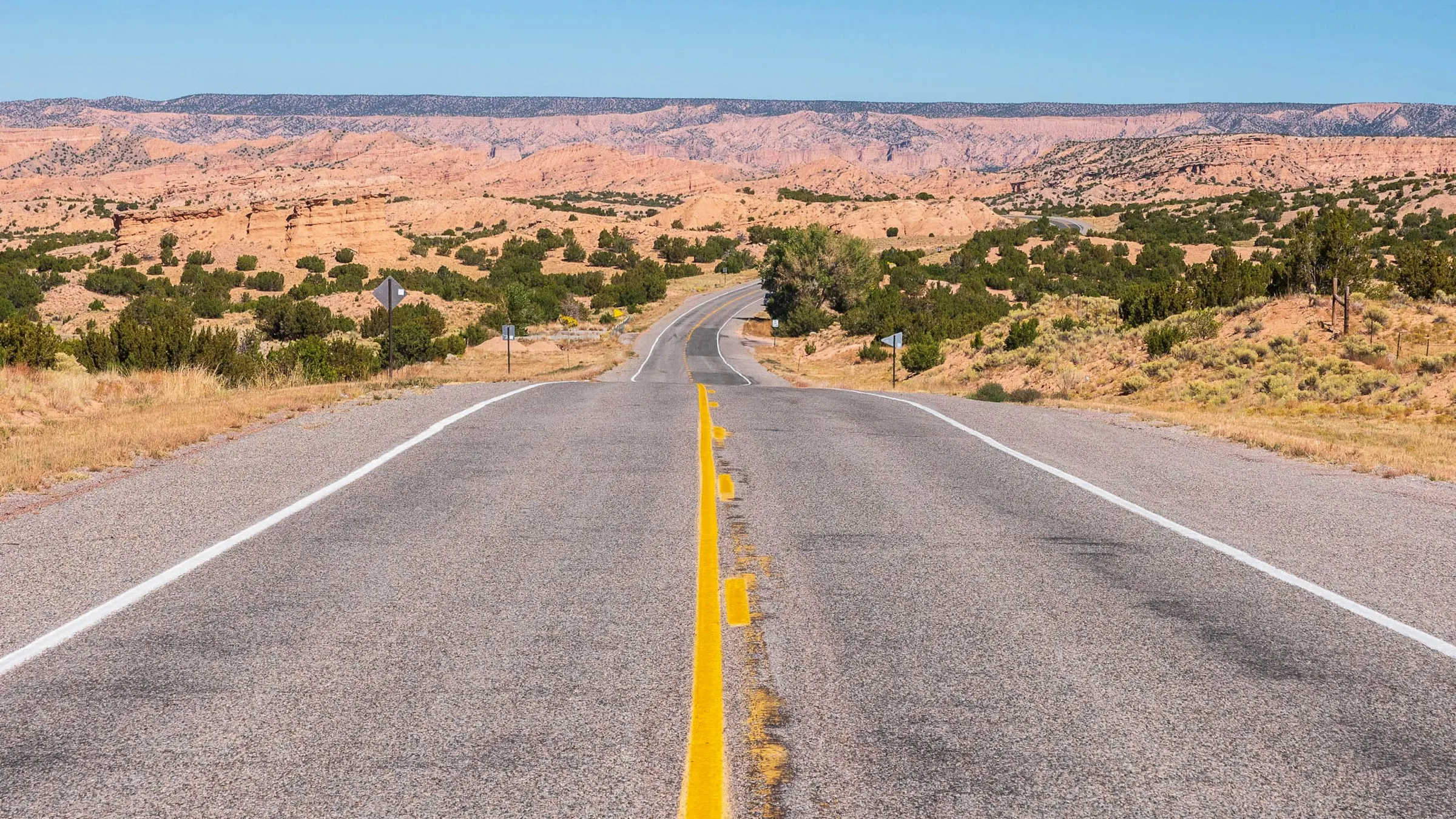 Person driving through desert highway in New Mexico