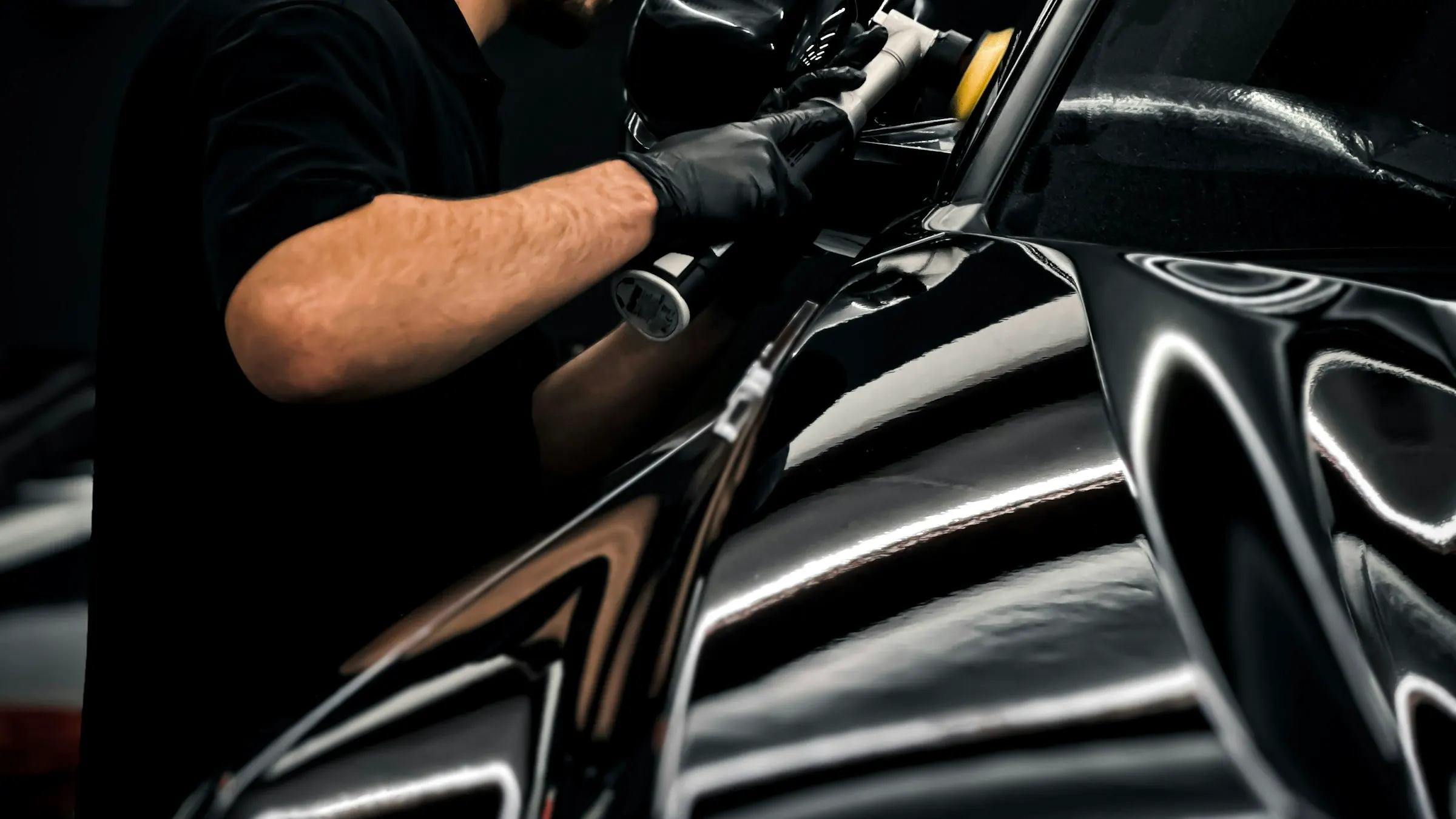 Auto glass technician performing precision work on a windshield