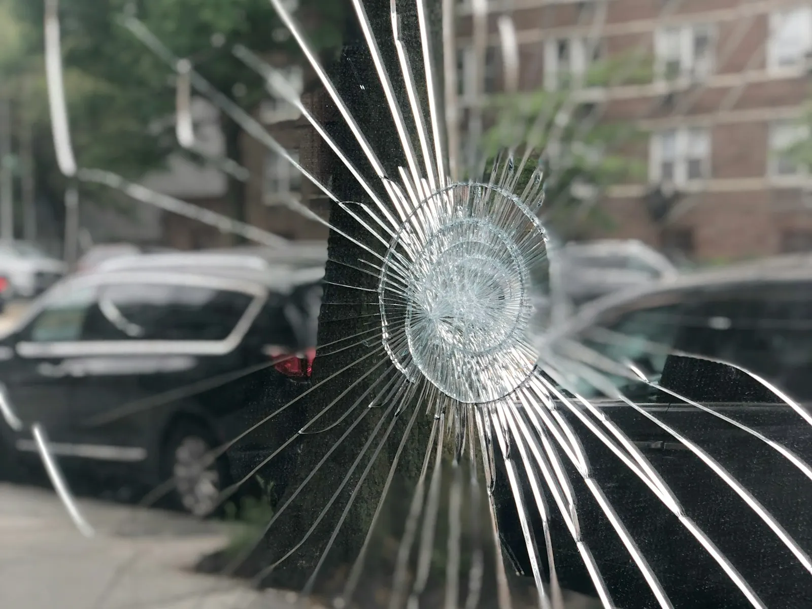 Close-up of repairable rock chip on windshield glass
