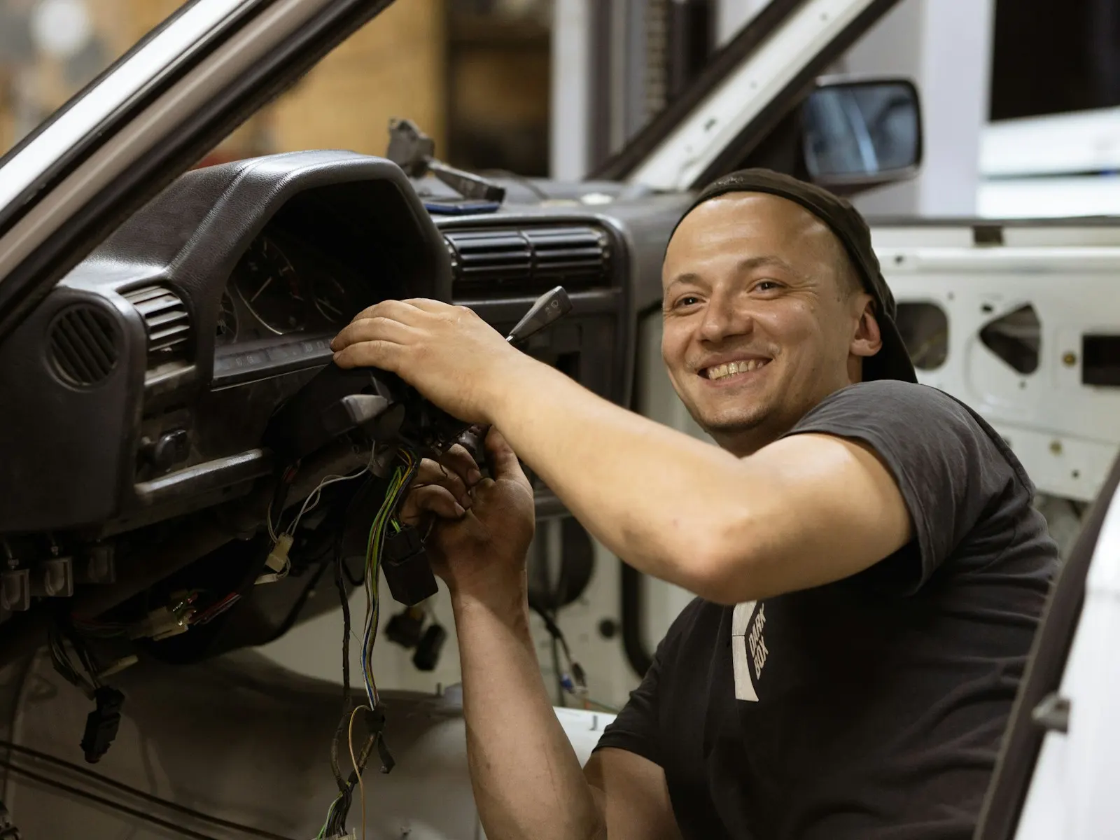 Mechanic installing a new windshield on a vehicle